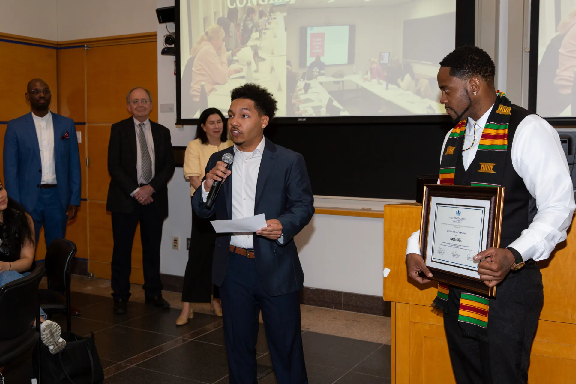 Photo of student presenting at graduation ceremony